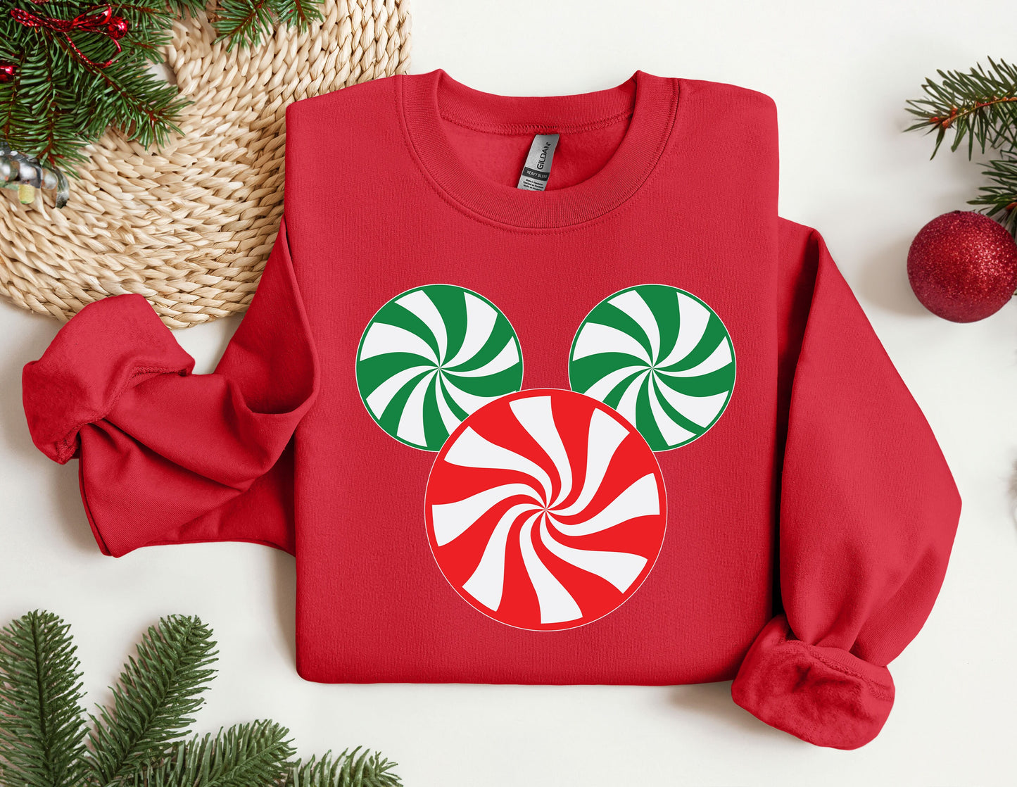 a red sweatshirt with a green and white candy cane on it