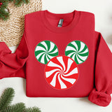 a red sweatshirt with a green and white candy cane on it