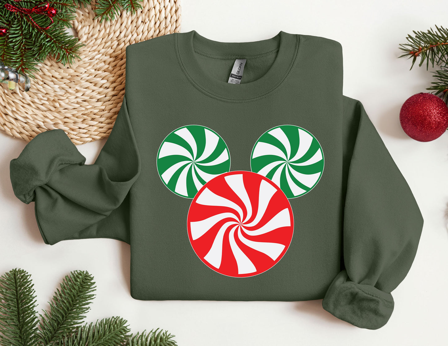 a green sweatshirt with a red and white candy cane on it