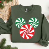 a green sweatshirt with a red and white candy cane on it