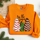 an orange shirt with a christmas tree and two trees on it