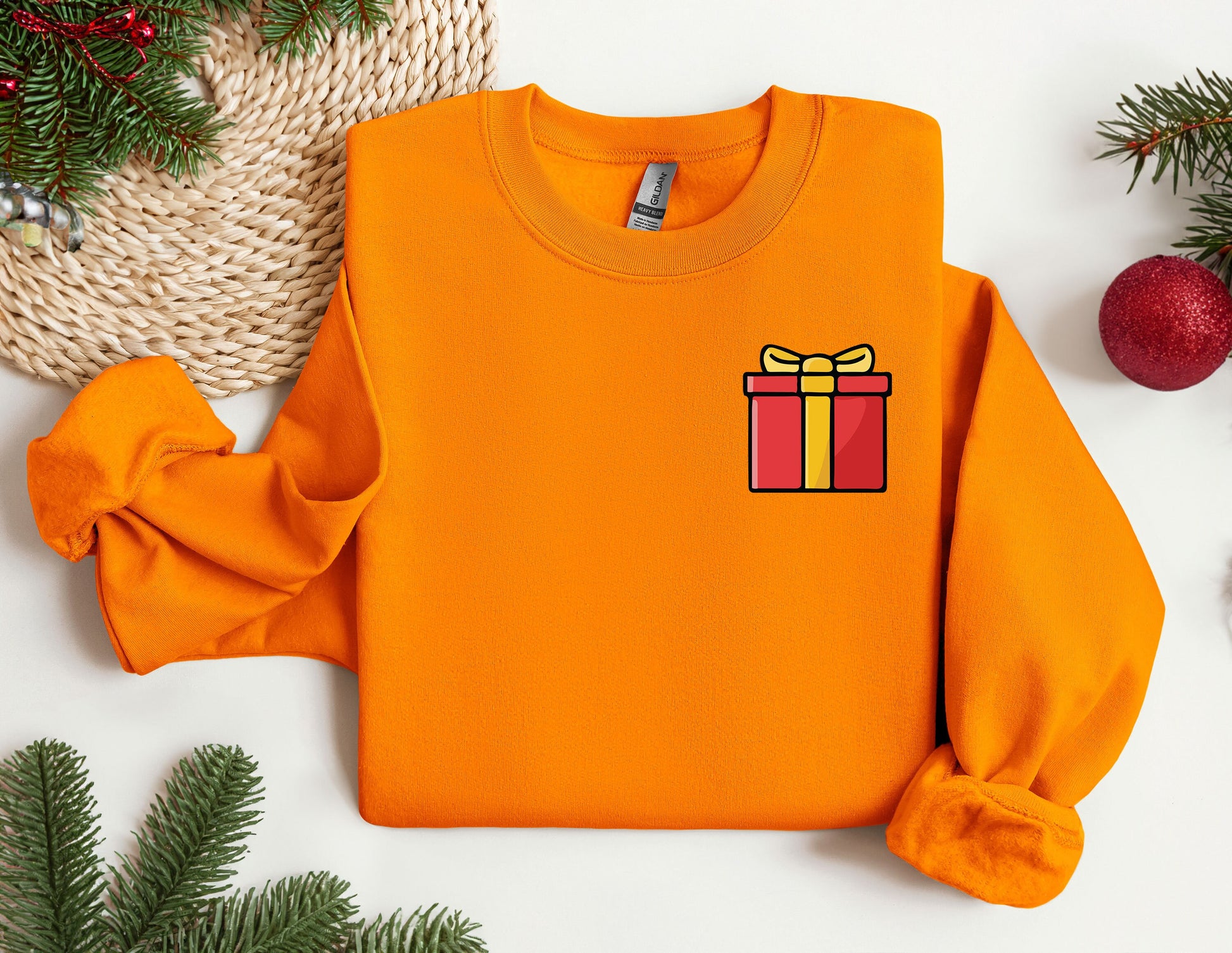 an orange sweater with a gift box on it