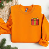 an orange sweater with a gift box on it