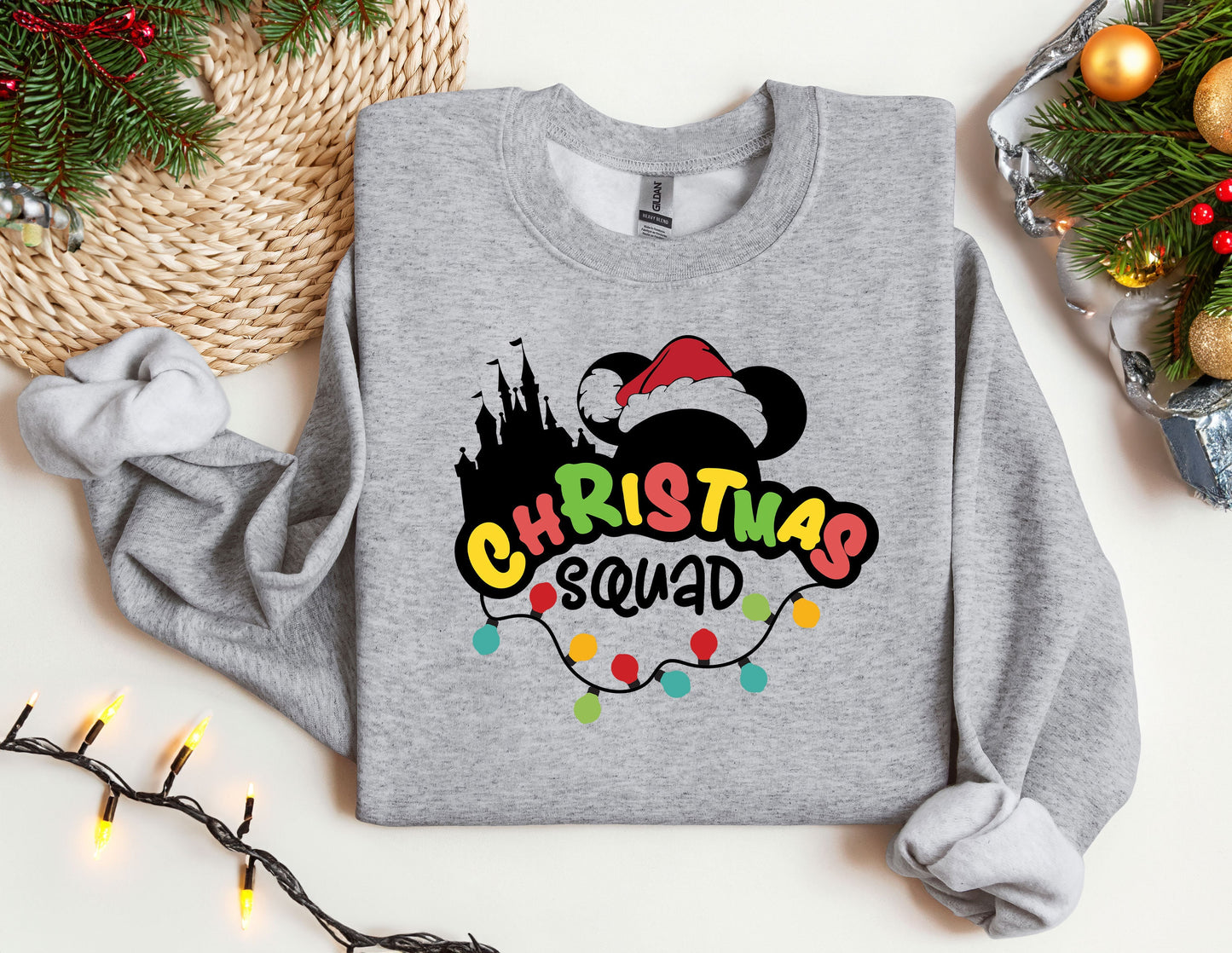 a mickey mouse christmas sweatshirt sitting on top of a table