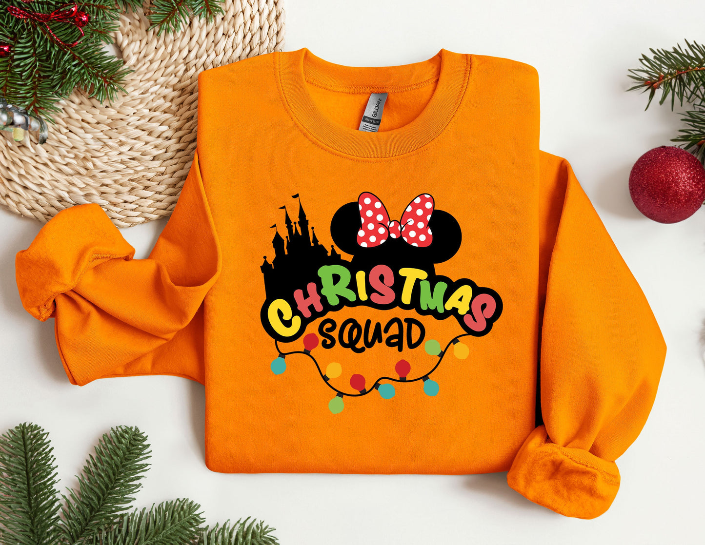 an orange sweatshirt with a mickey mouse christmas squad on it