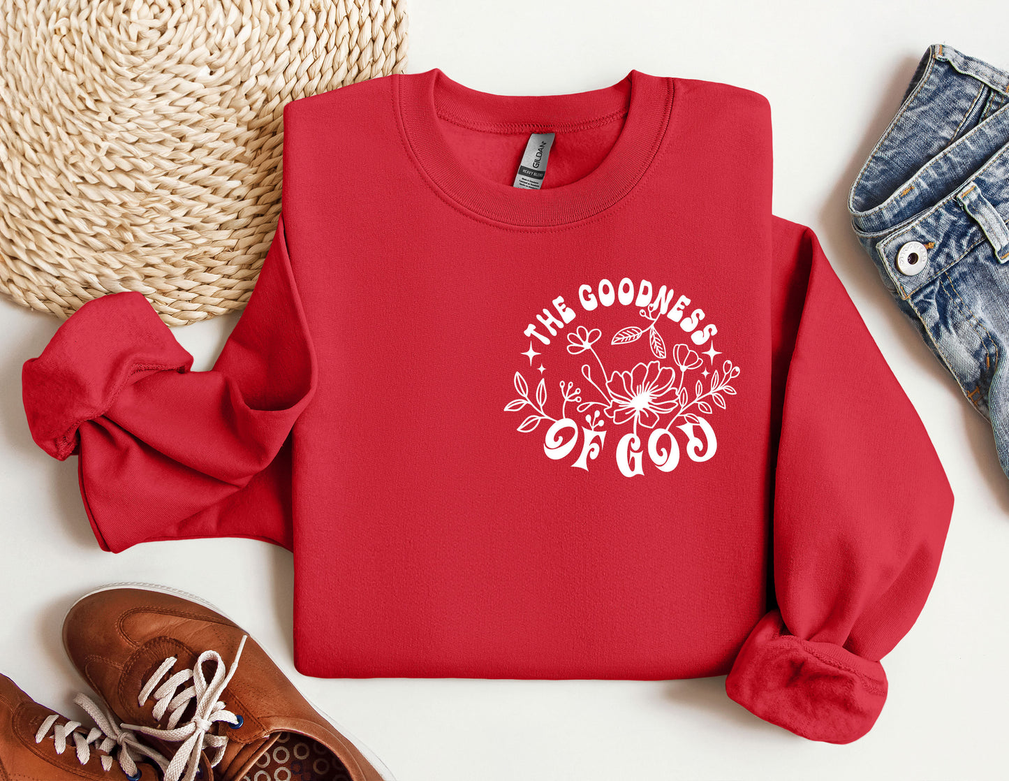 a red sweatshirt with the words the goodness of god printed on it