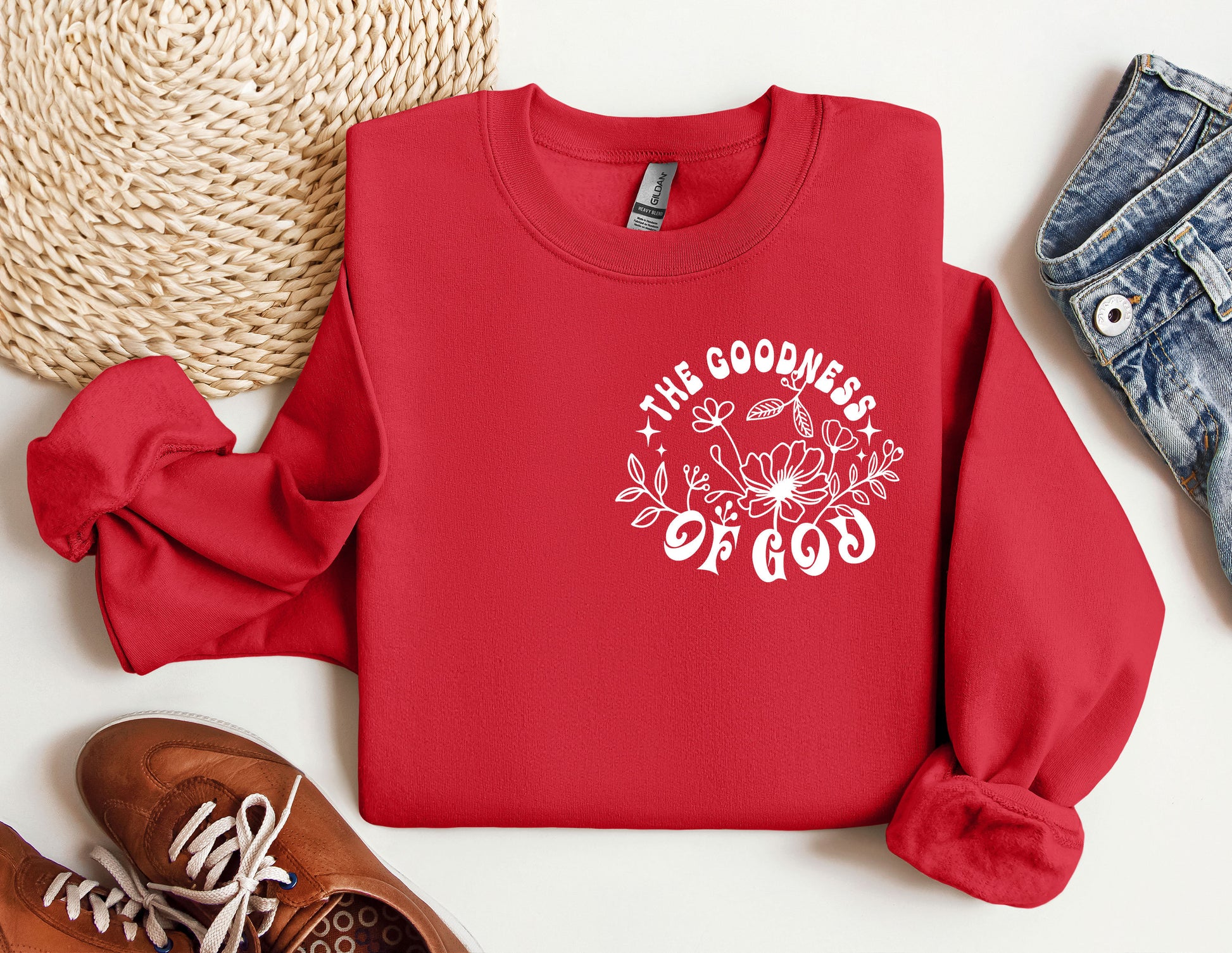 a red sweatshirt with the words the goodness of god printed on it