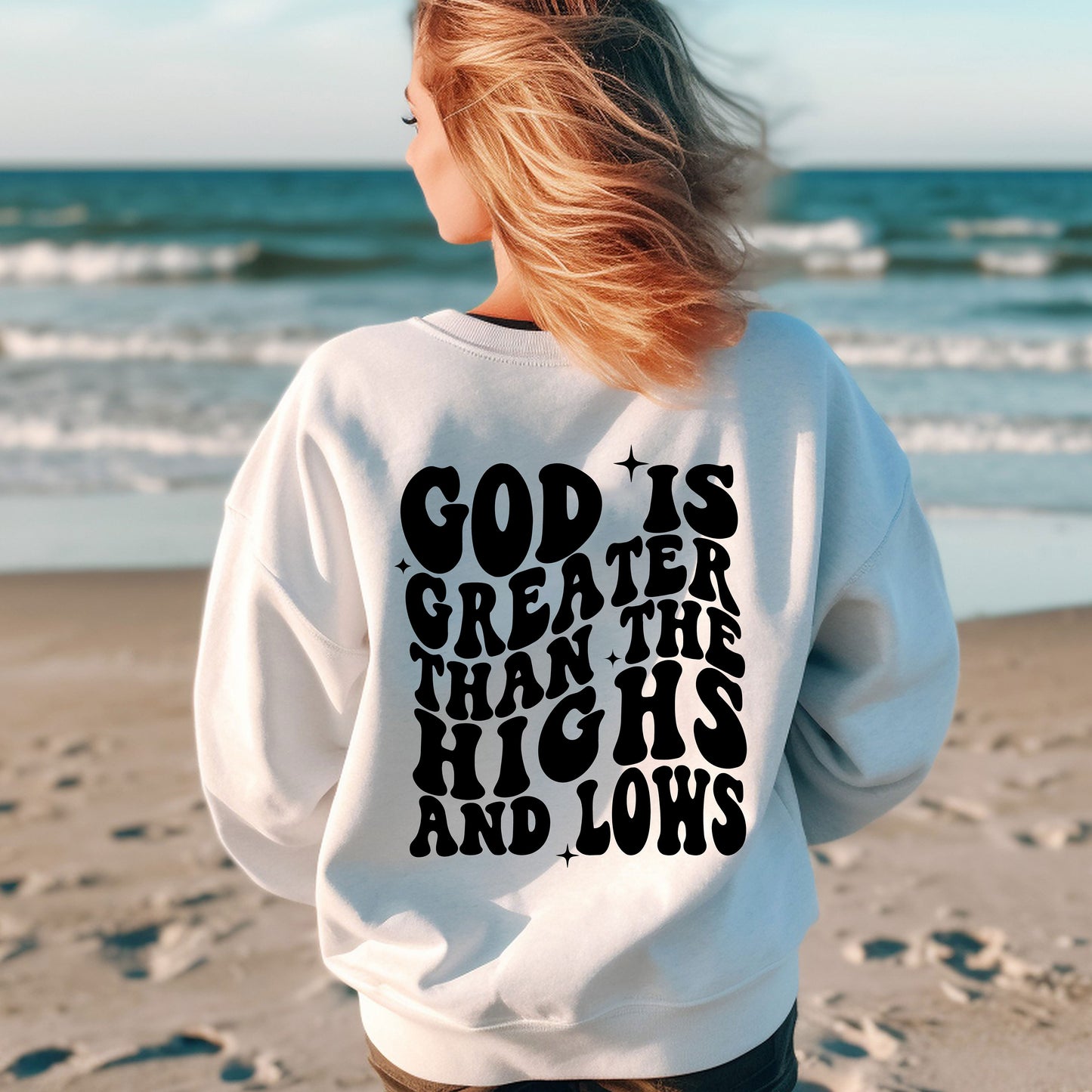 a woman standing on a beach with her back to the camera