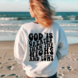 a woman standing on a beach with her back to the camera