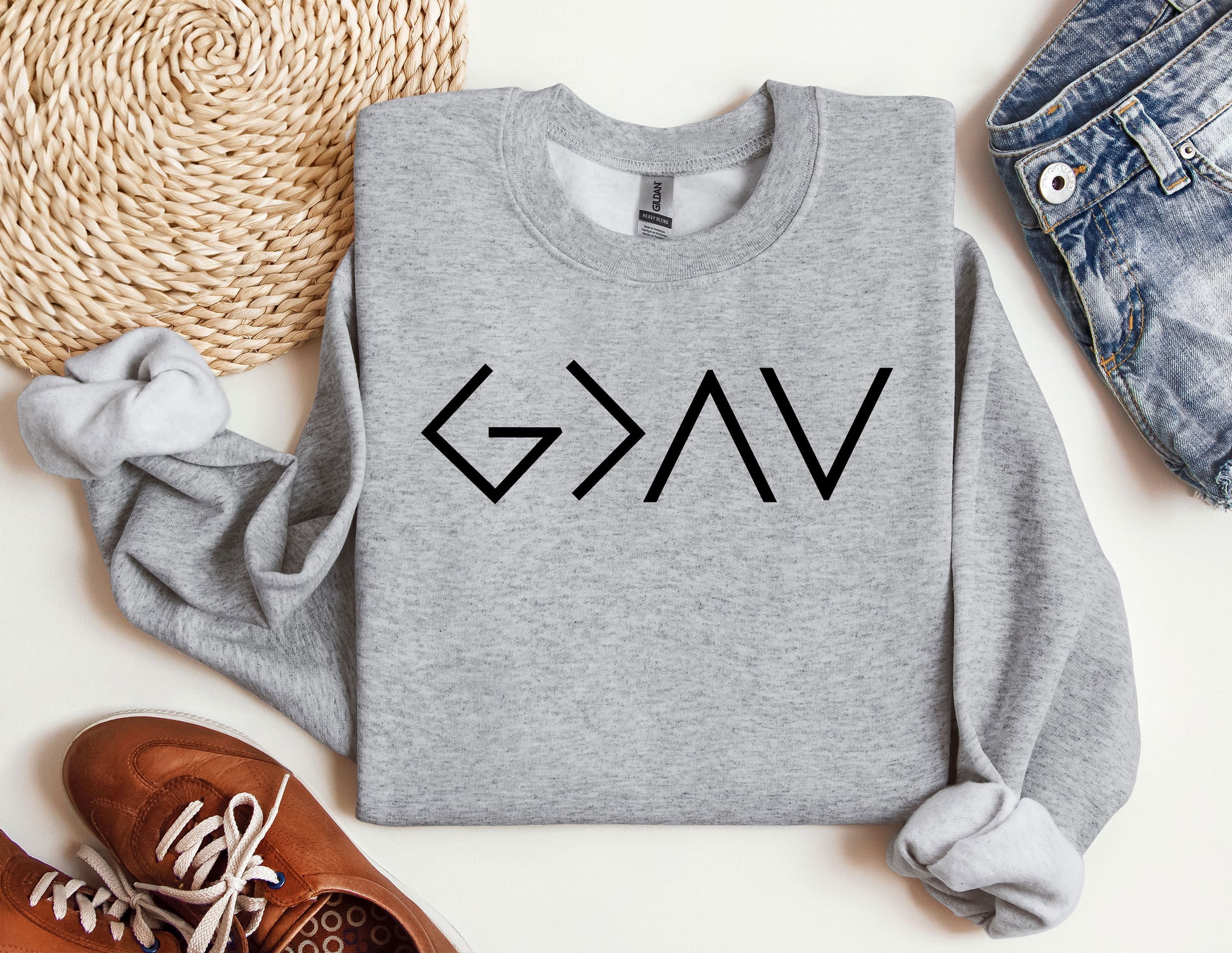 a grey sweatshirt with the word vak on it next to a pair of shoes