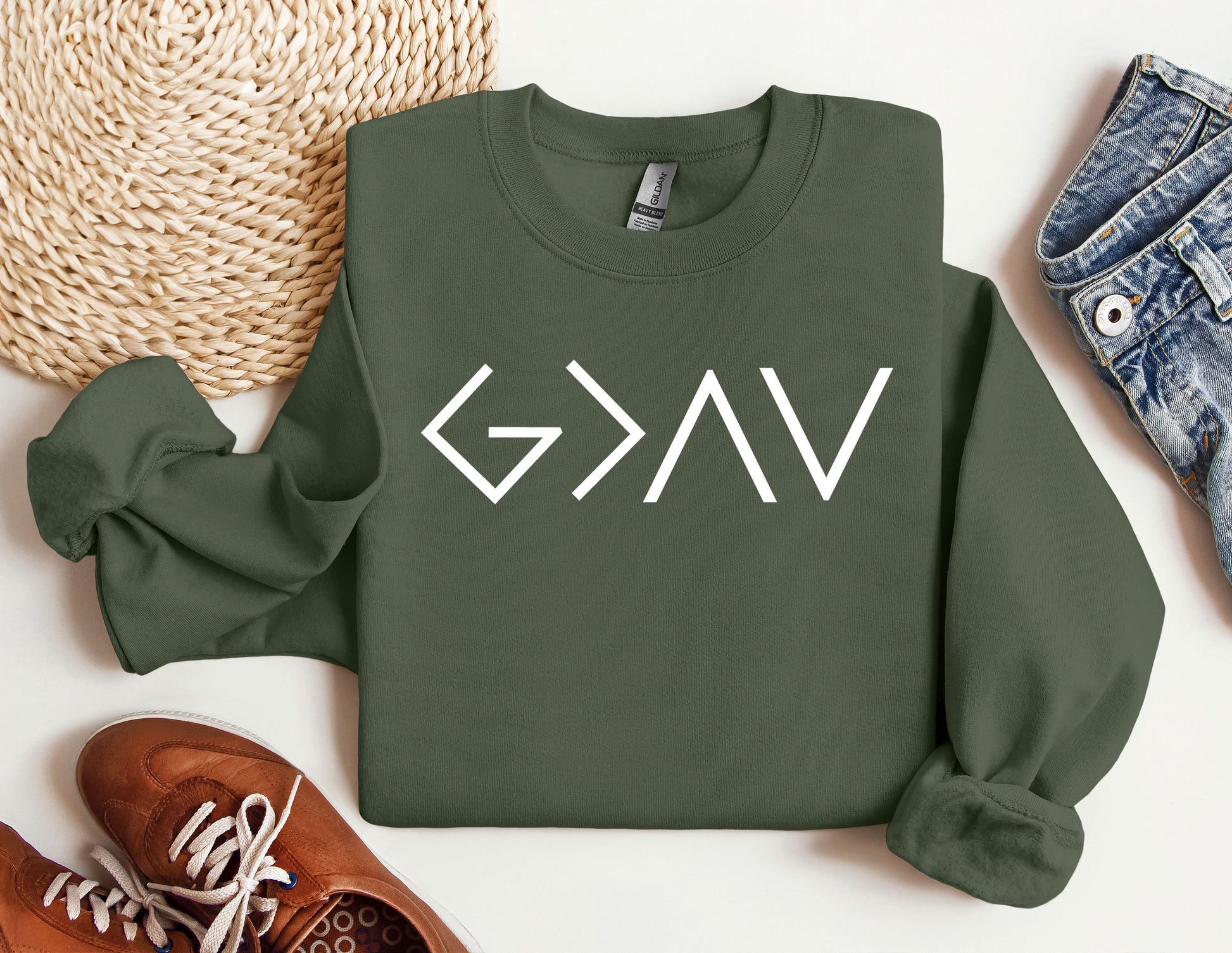 a green sweatshirt with the word gvg on it next to a pair of