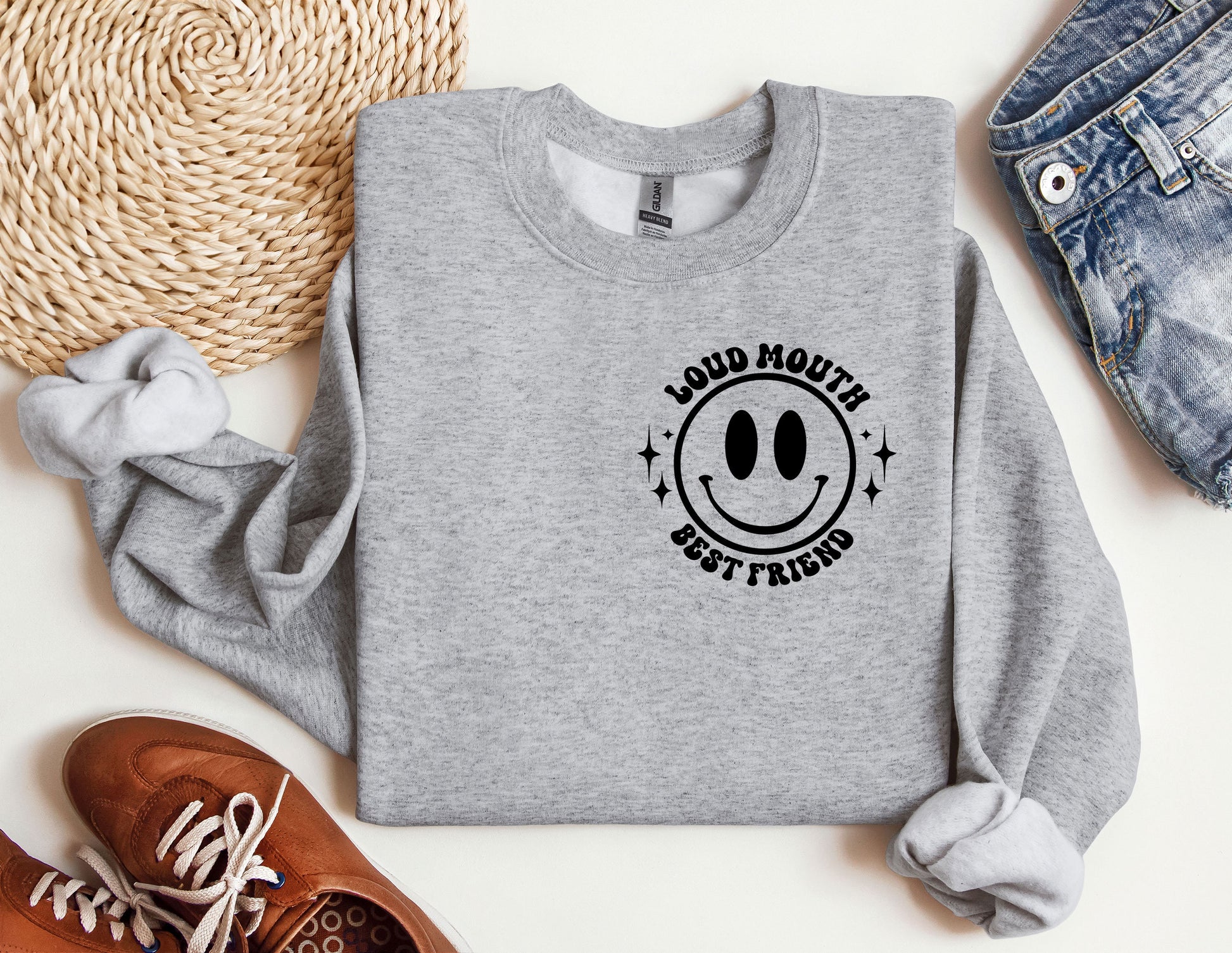 a grey sweatshirt with a smiley face on it