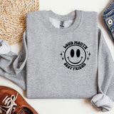 a grey sweatshirt with a smiley face on it