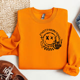 a pair of shoes and an orange sweatshirt on a white surface