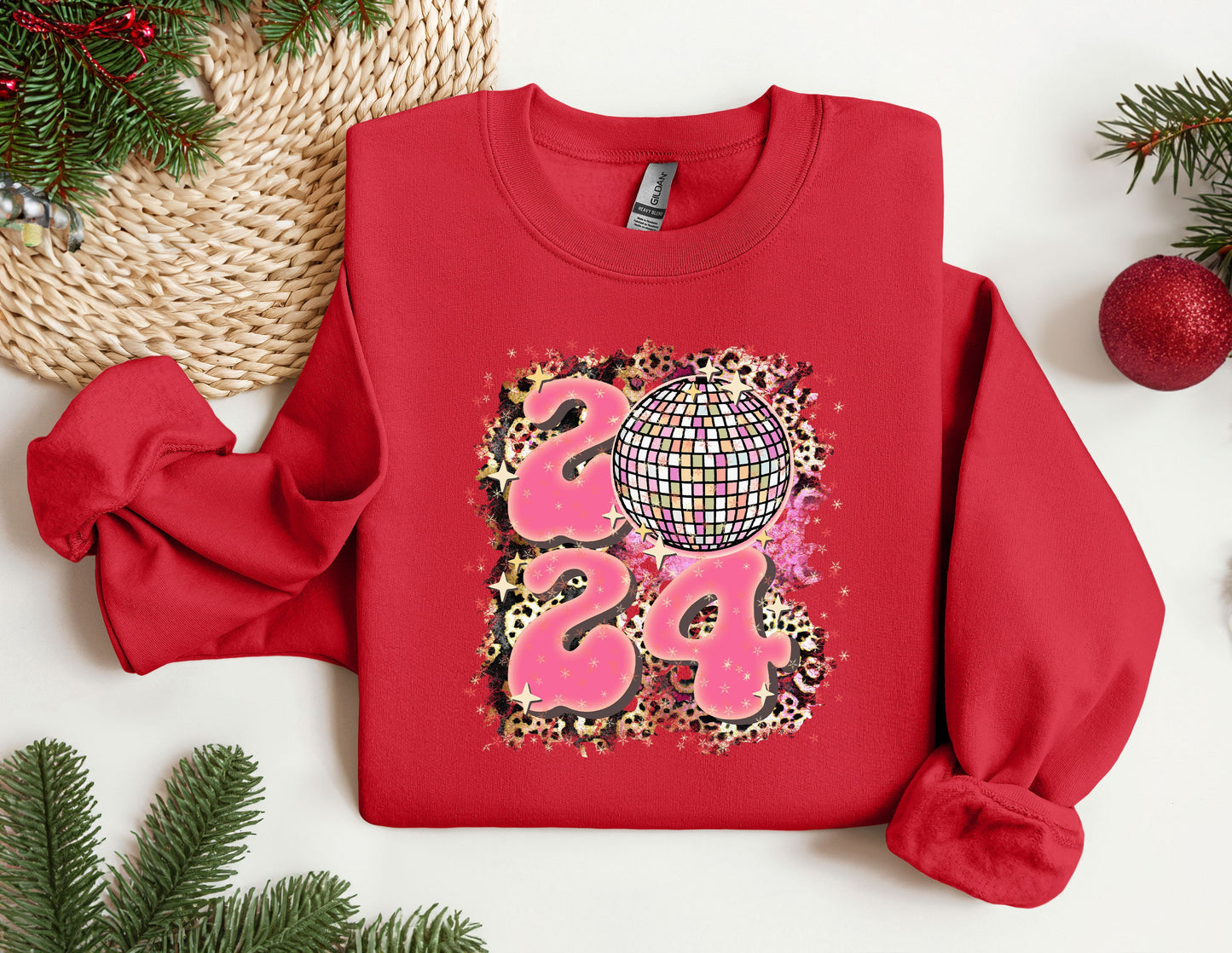 a red sweater with a disco ball on it