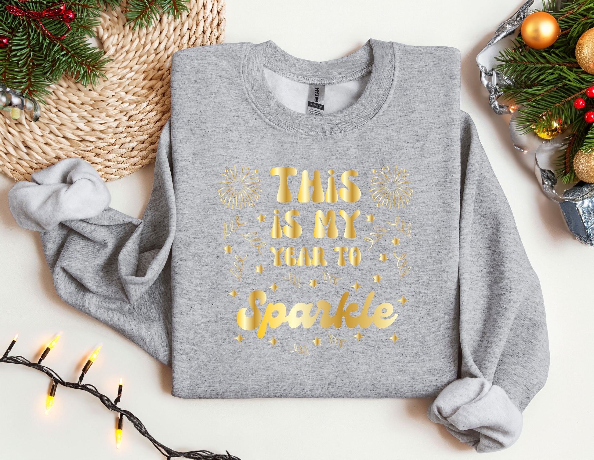 a grey sweatshirt with gold lettering on it