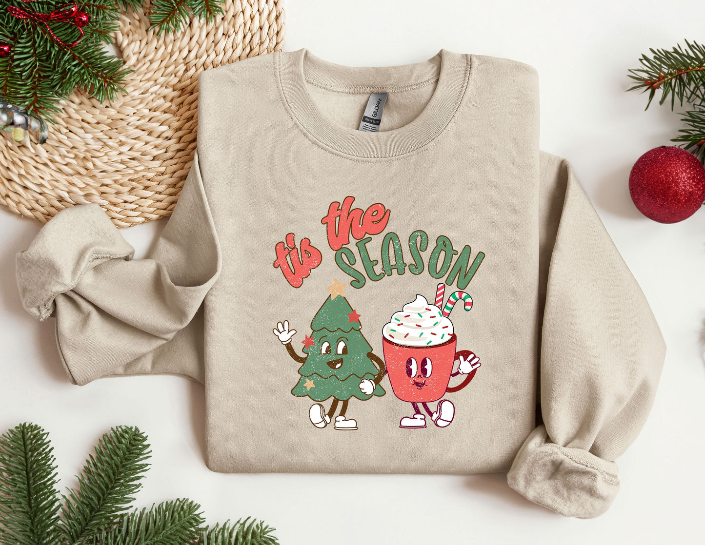 a sweater with a christmas tree and a cup of coffee