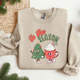 a sweater with a christmas tree and a cup of coffee