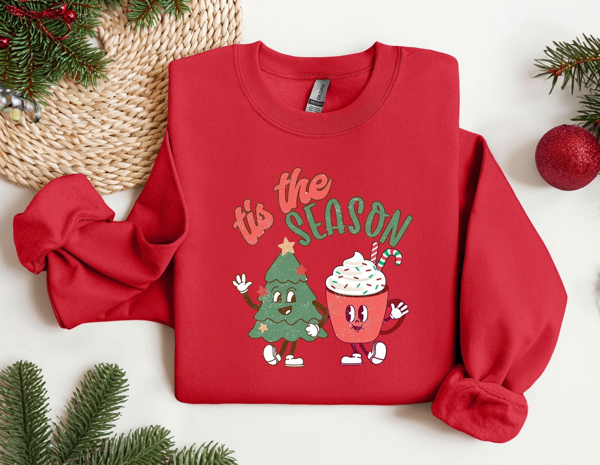 a red sweatshirt with a christmas tree and a cupcake on it