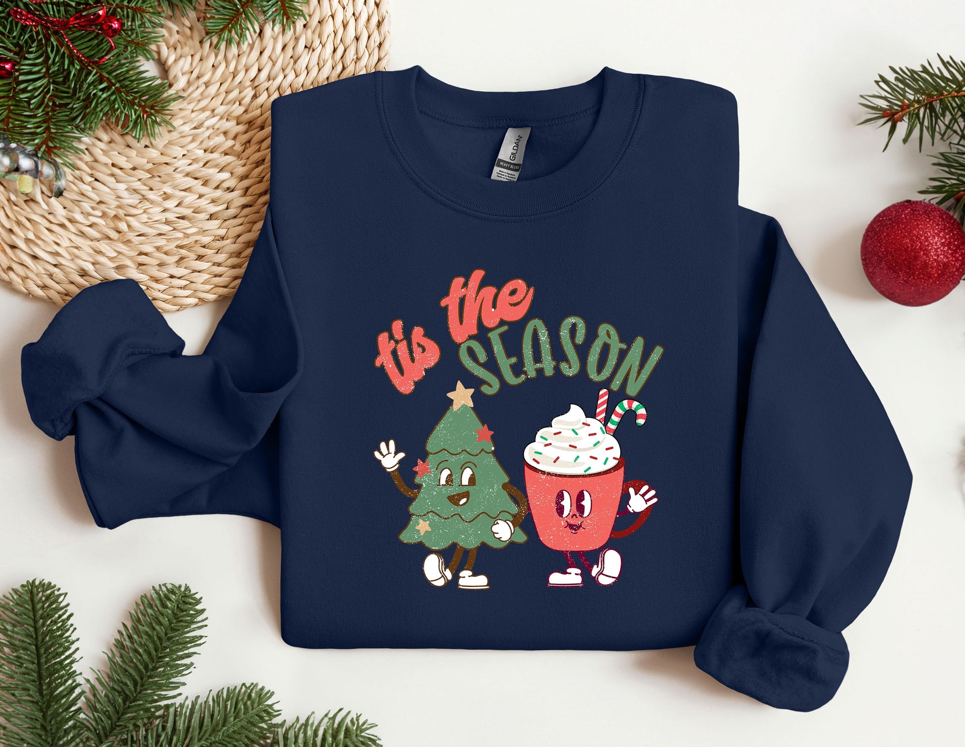 a blue sweatshirt with a christmas tree and a cupcake on it