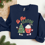 a blue sweatshirt with a christmas tree and a cupcake on it
