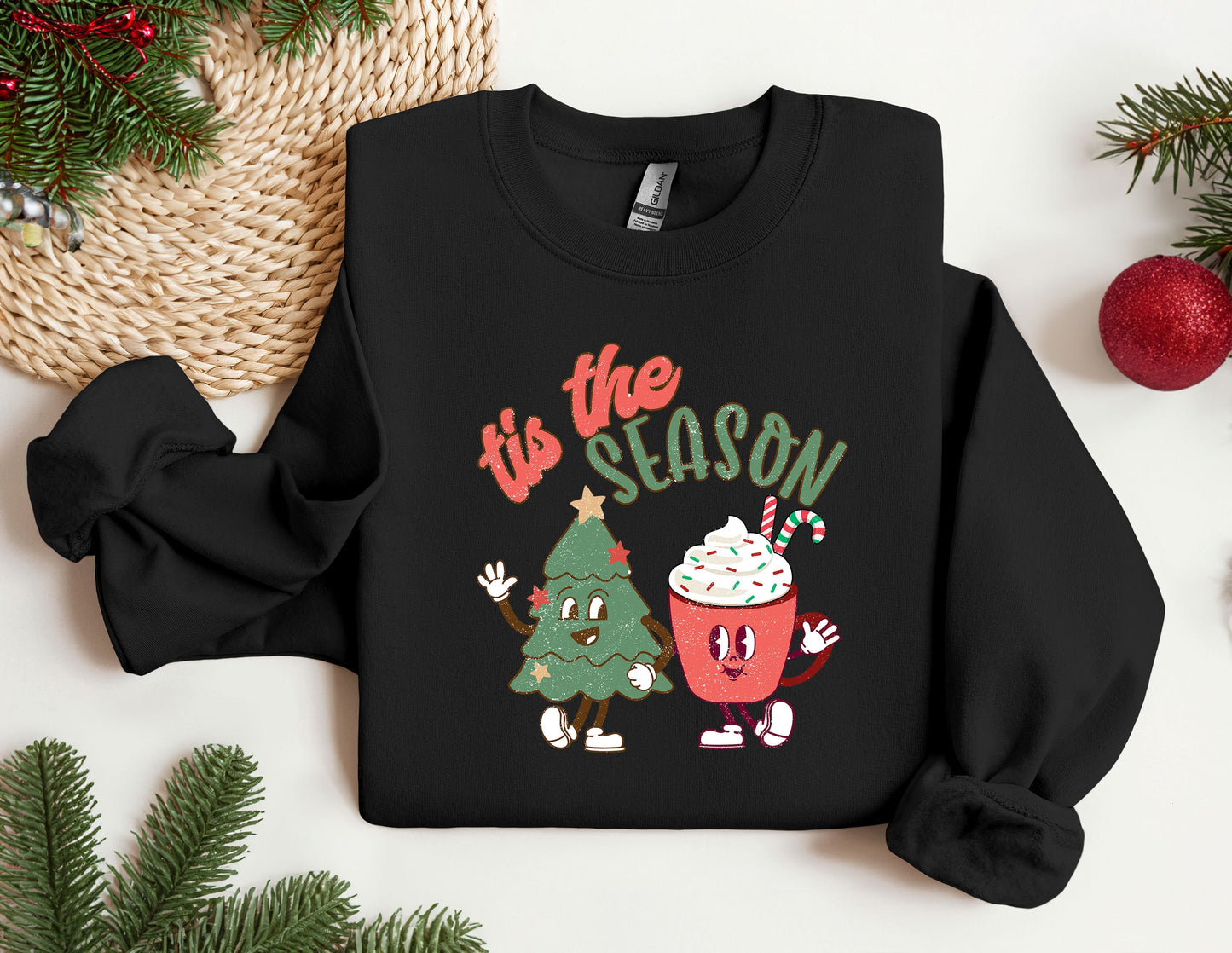 a black sweatshirt with a christmas tree and a cupcake on it