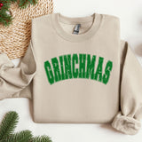 a christmas sweater with the word grinnas on it