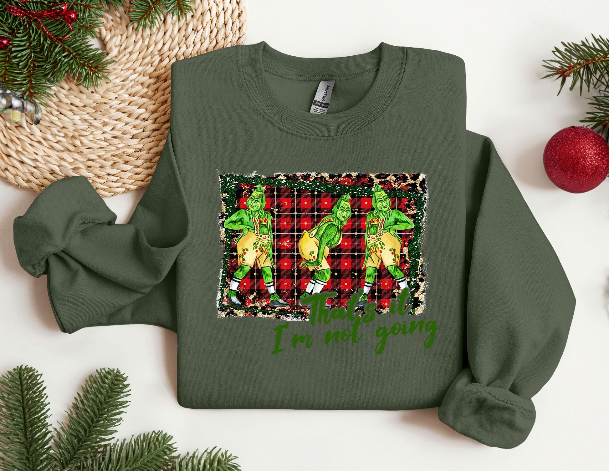 a green christmas sweater with a picture of two dogs on it