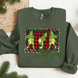 a green christmas sweater with a picture of two dogs on it