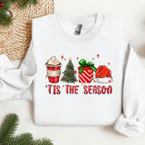 a white sweater with a christmas tree and presents on it