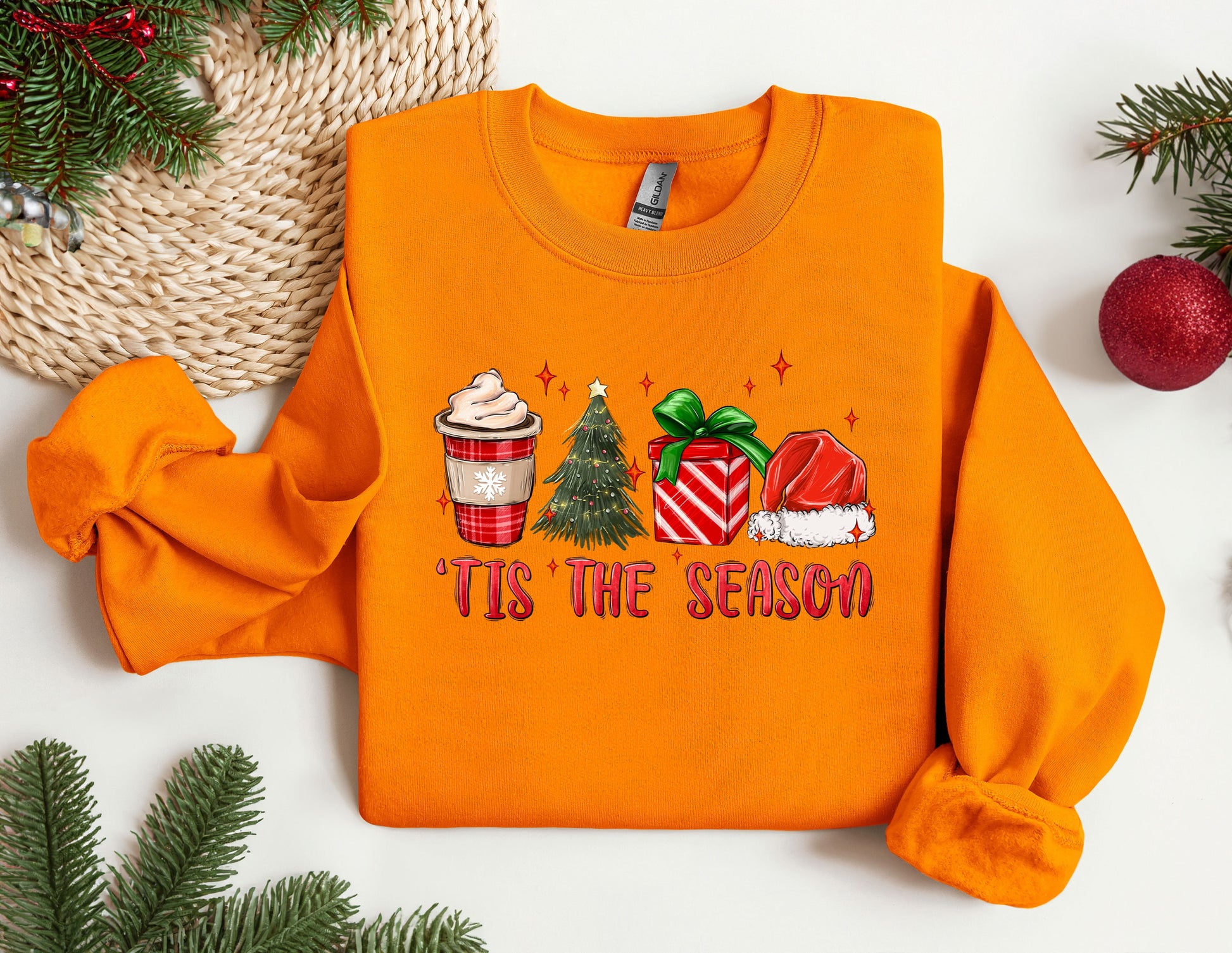 an orange sweater with a cup of coffee and a christmas tree on it