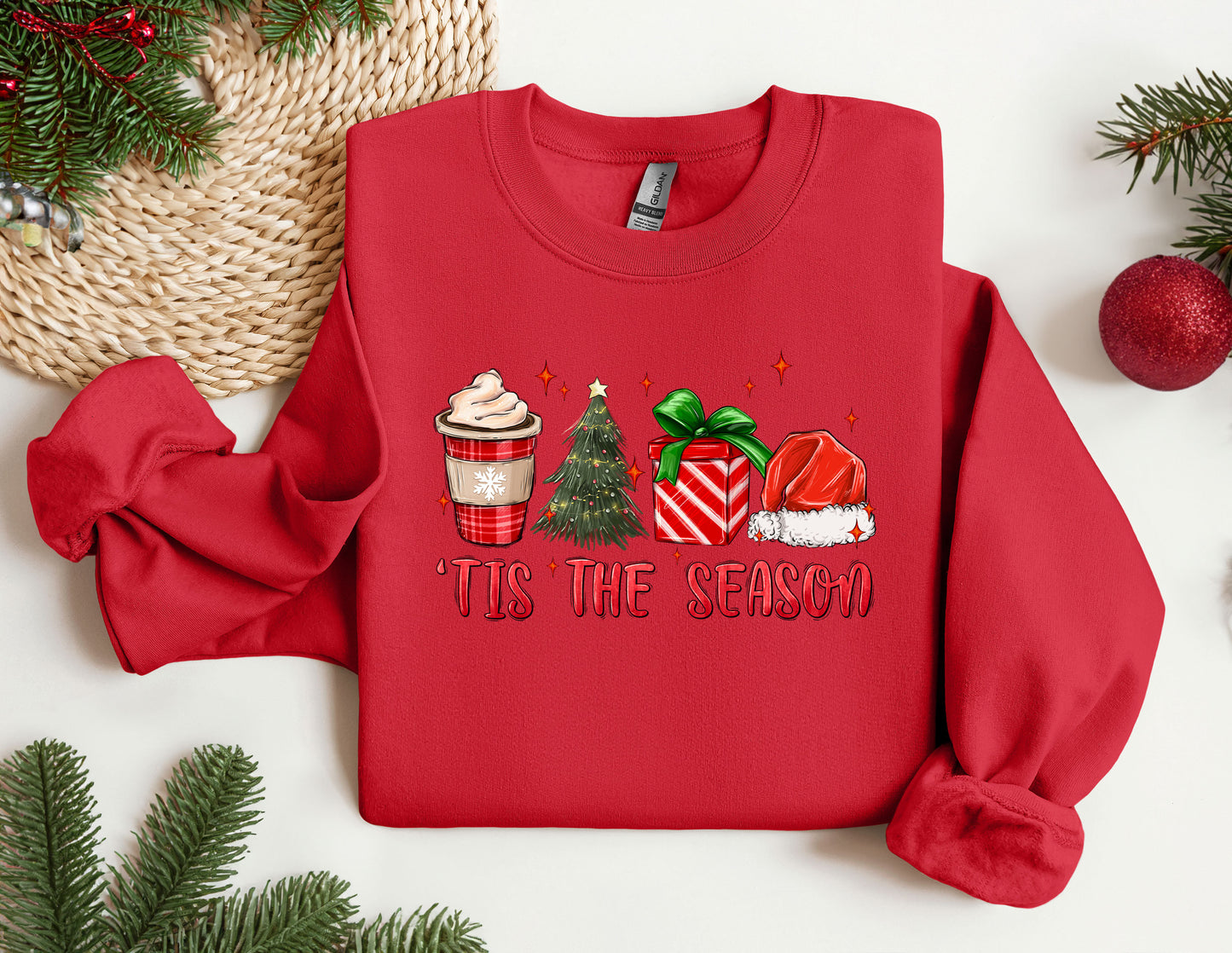 a red sweater with a christmas scene on it