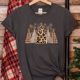 a t - shirt with a leopard print on it next to a christmas tree