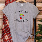 a t - shirt that says whoville university on it next to a christmas tree