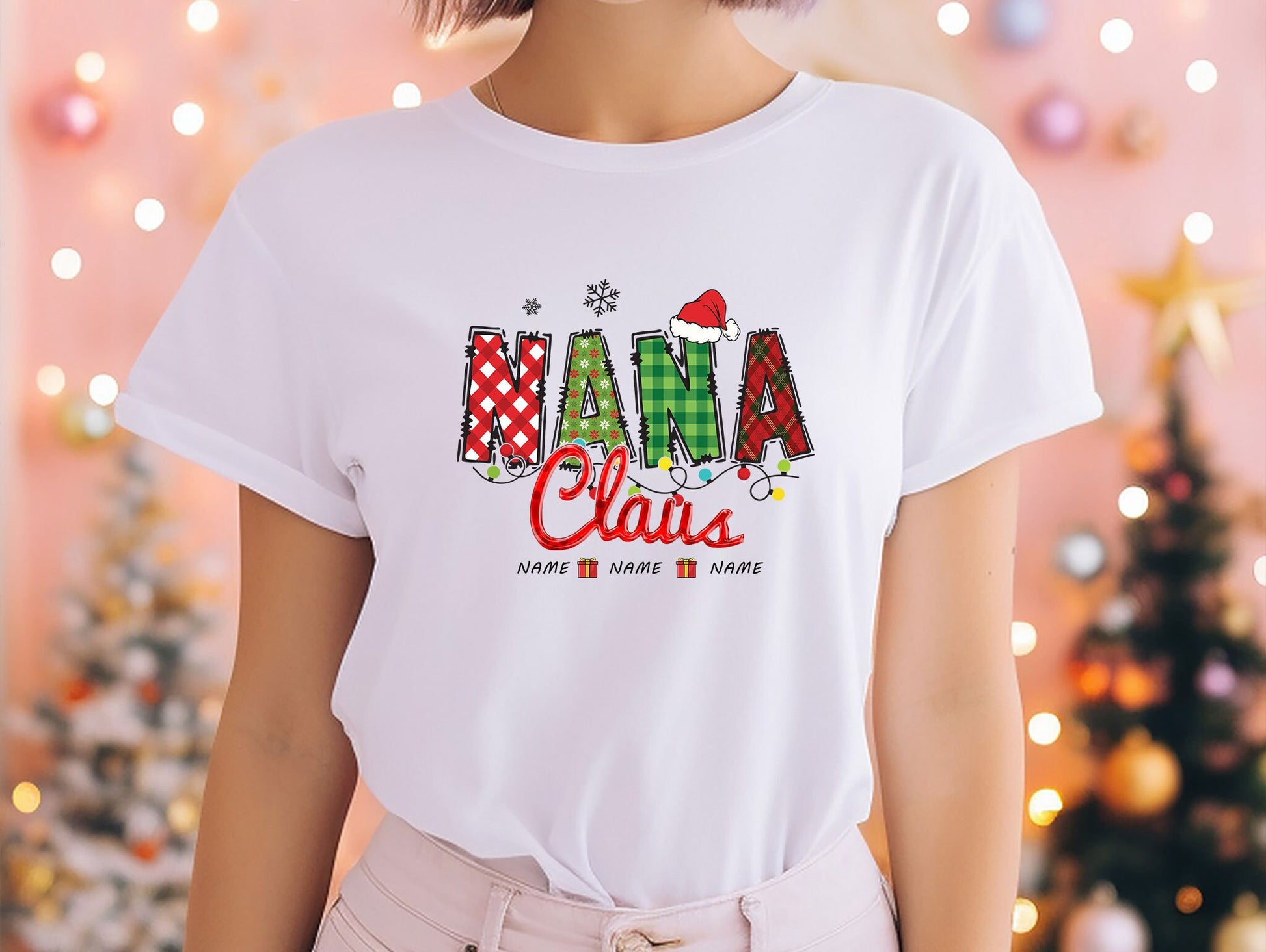 a woman wearing a white t - shirt with the word mama claus printed on it