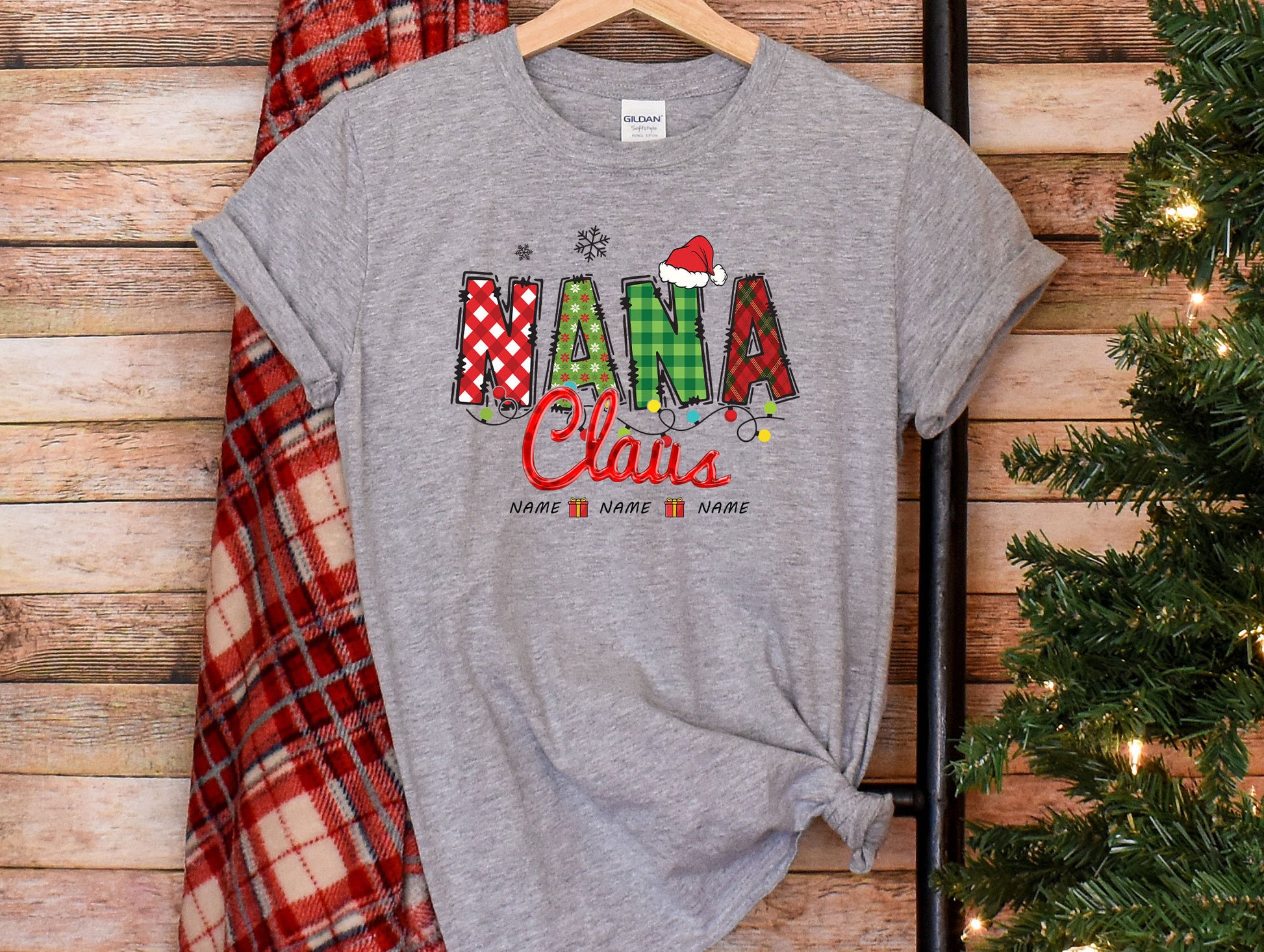 a t - shirt with the word mama claus on it next to a christmas tree