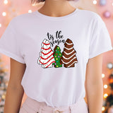 a woman wearing a t - shirt that says tis the season
