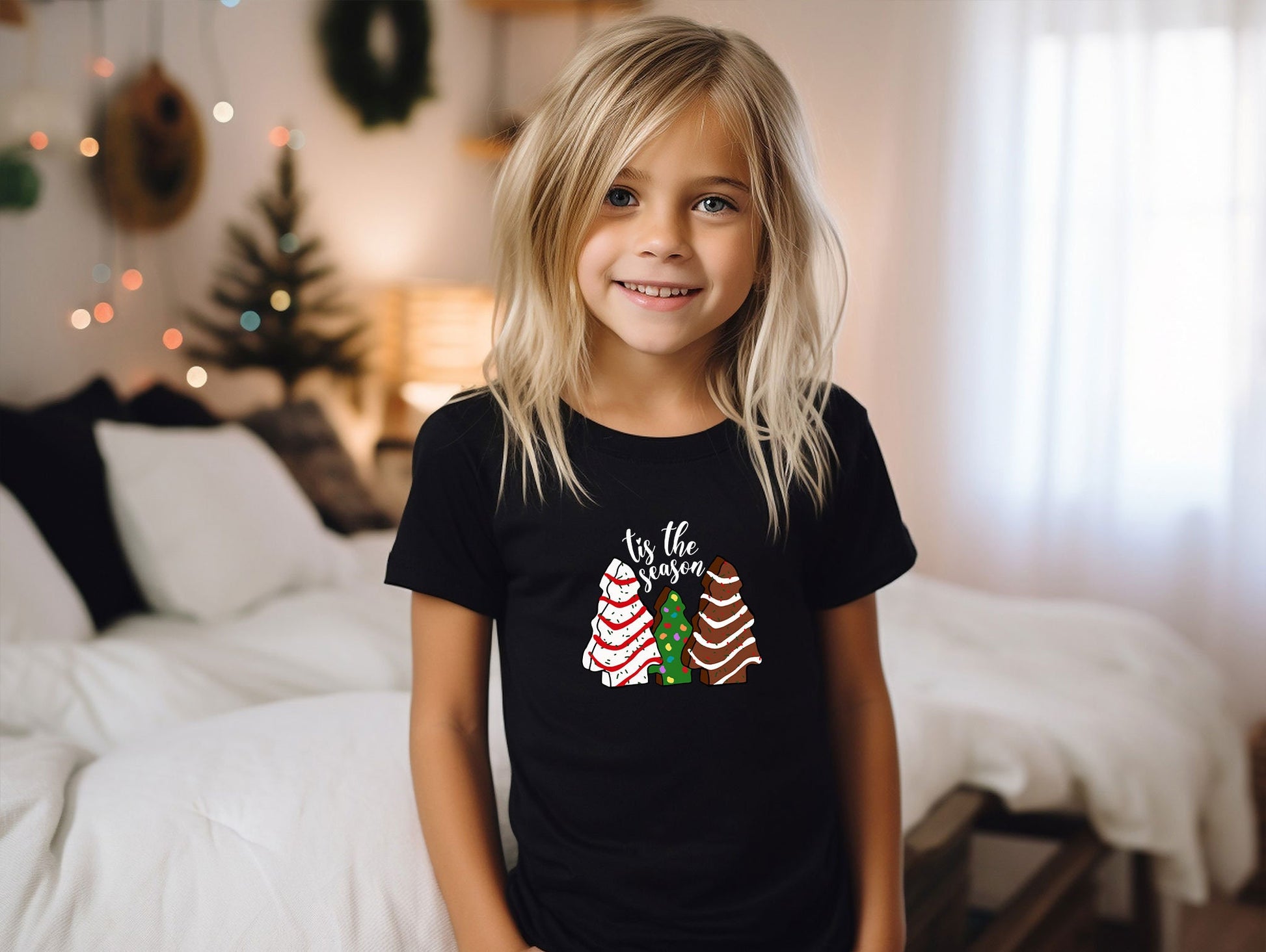 a little girl standing in front of a bed