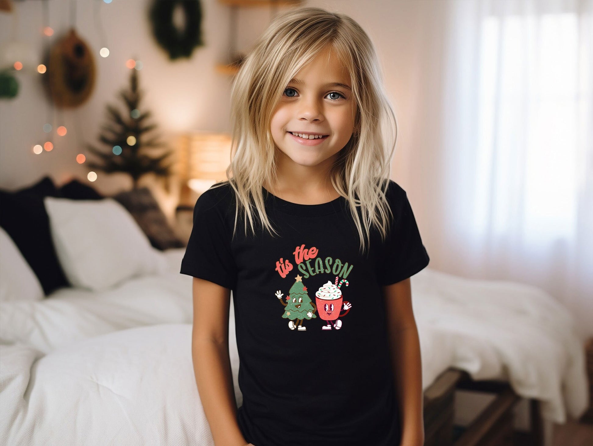 a little girl that is standing in front of a bed