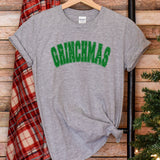 a t - shirt with the word grinna's on it next to a