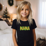 a little girl that is standing in front of a bed