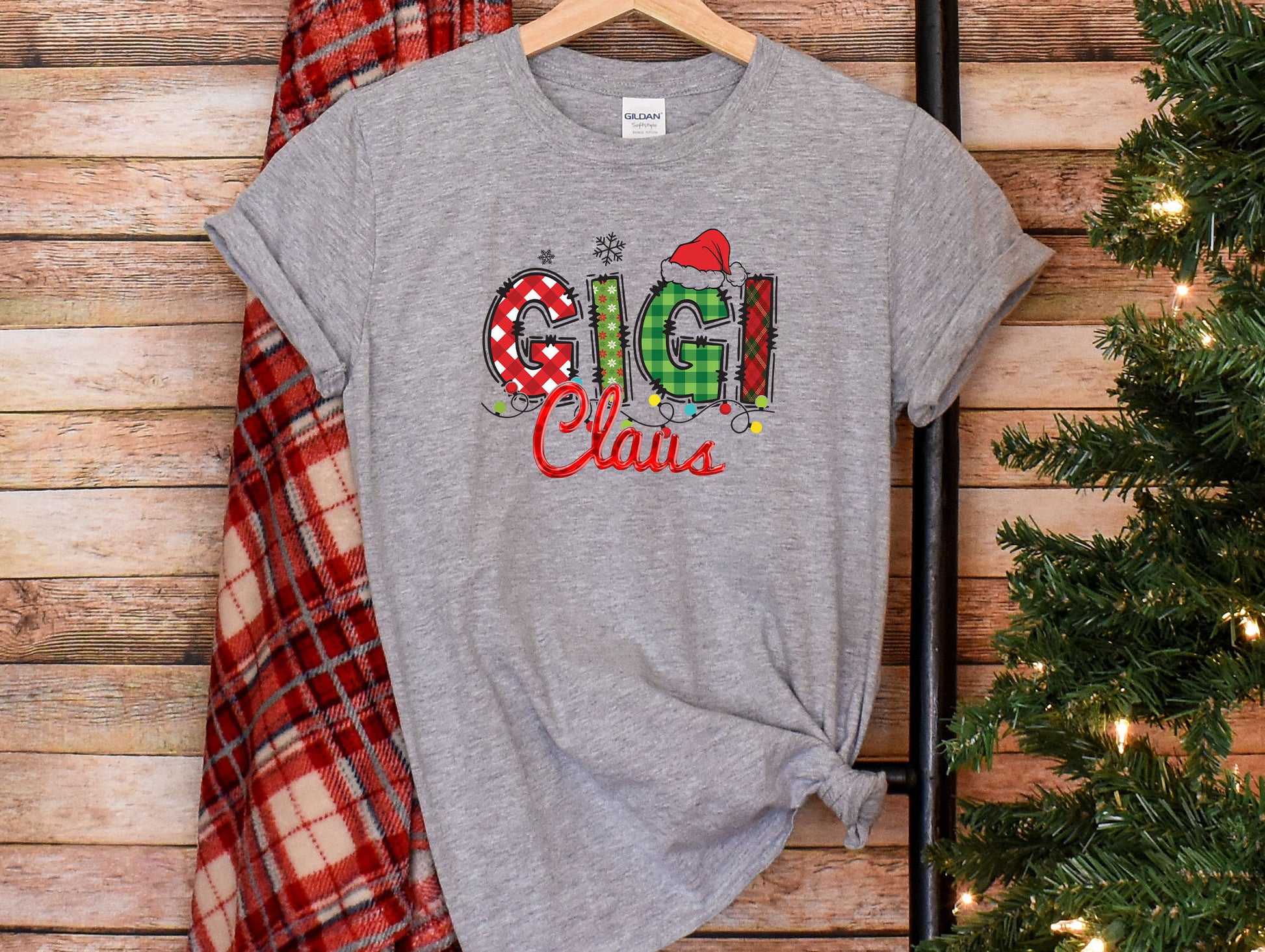 a t - shirt with the word grin on it next to a christmas tree