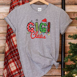 a t - shirt with the word grin on it next to a christmas tree
