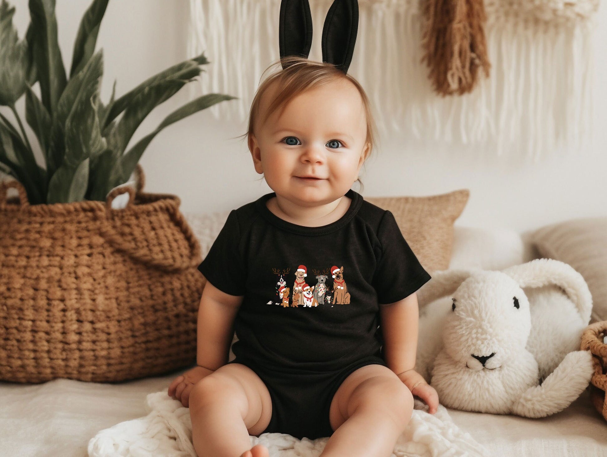 a baby sitting on a bed next to a stuffed animal