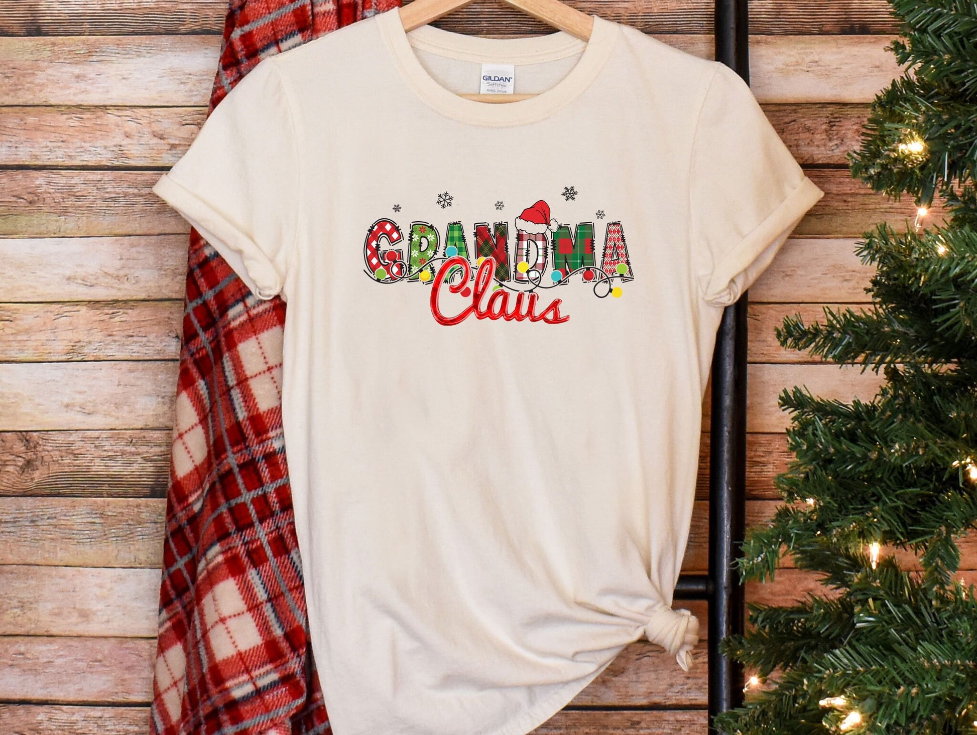 a t - shirt that says grandma claus hanging on a wall