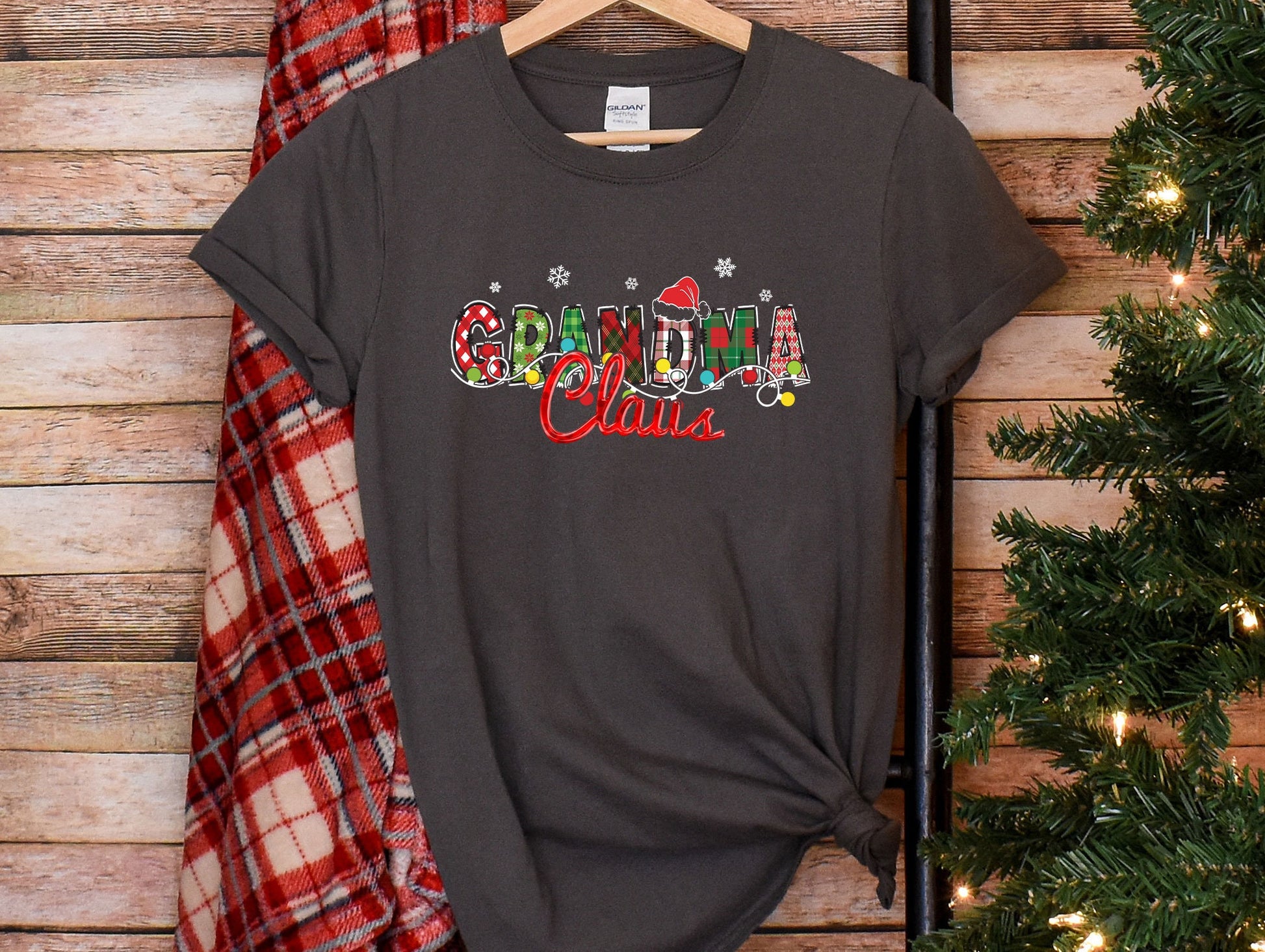 a t - shirt with the word grandma on it next to a christmas tree