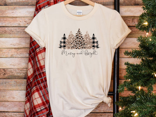 a t - shirt that says merry and bright next to a christmas tree