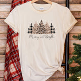 a t - shirt that says merry and bright next to a christmas tree