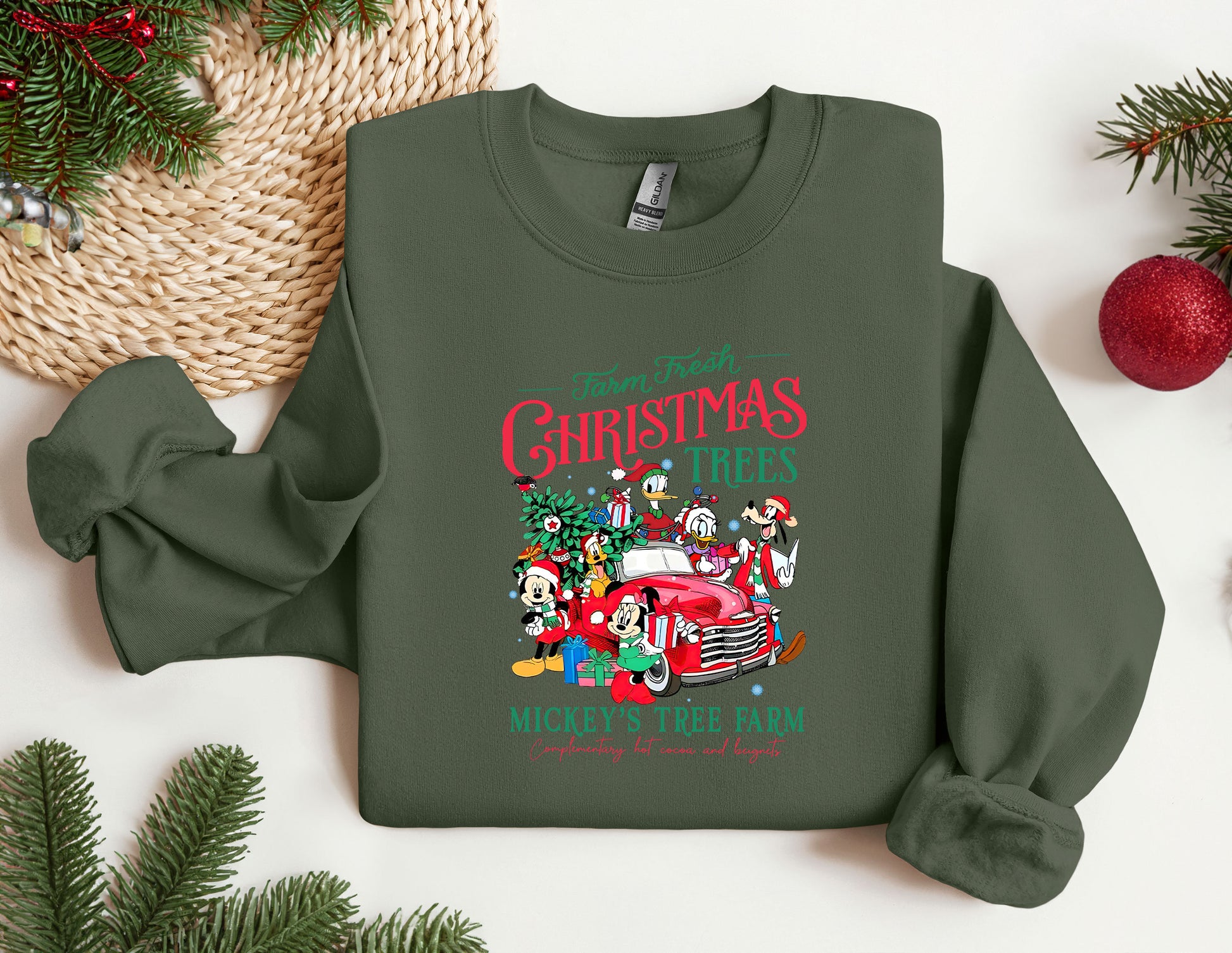 a green christmas sweater with a red truck and santa clause on it