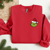 a red sweater with a green grin face on it